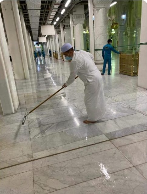 Photo of Malaysian minister assists workers in sweeping rainwater