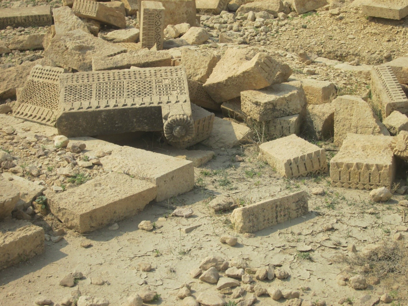 07 Carved stone slabs scattered on surface with rosette and square Motifs - Sindh Courier
