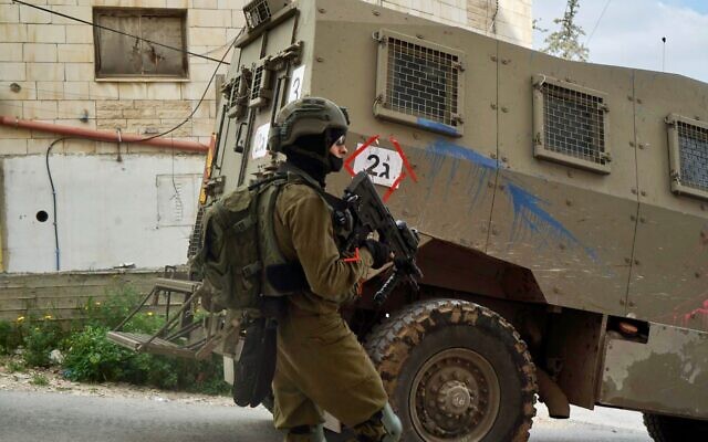 An Israeli soldier is seen during a raid in the Jenin refugee camp in the northern West Bank,
