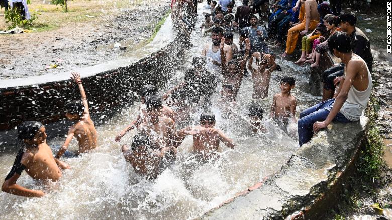 People cool themselves in a canal in Lahore, Pakistan, on April 29.