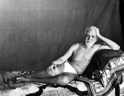 Ramana Maharshi reclining in the Old Hall where he lived from 1927 to 1950.