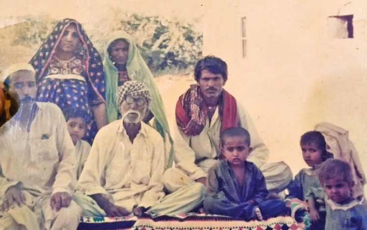 Jan Muhammad (first from the left in the front) and Rehmat Bai (first from left at the rear) with a new Ismaili family in Khebar