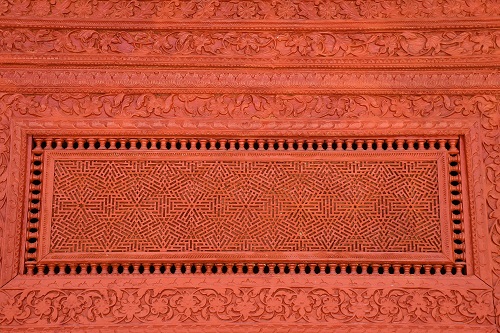 A detail of wood carvings on the arched entrance of the Jamia Mosque Jasial