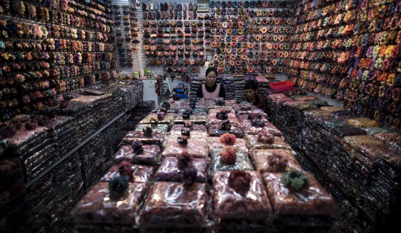 A vendor at a wholesale market in Yiwu Zhejiang province - AFP