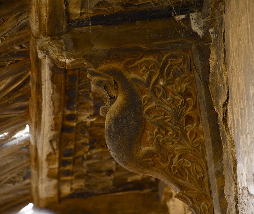 A wooden bracket with a depiction of Makara in a Maari in Khaman village