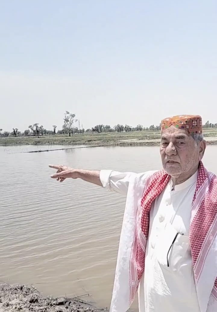 Abdul Sattar Qureshi showing his inundated lands